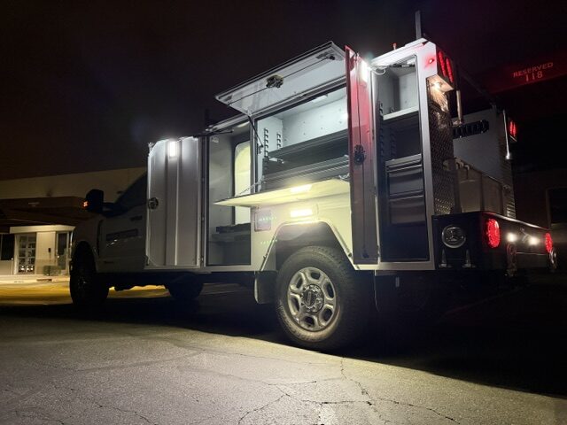 Watt Ventures service body, compartments open, lit up at dusk